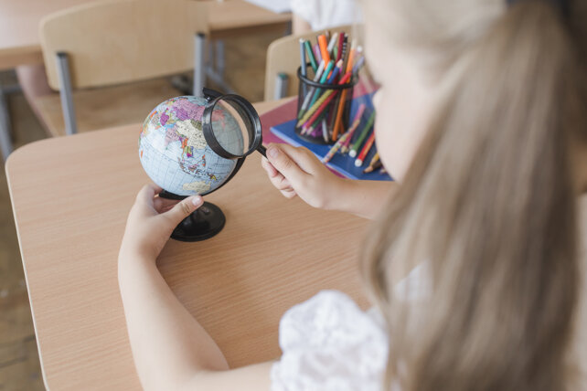 unrecognizable-girl-examining-globe.jpeg