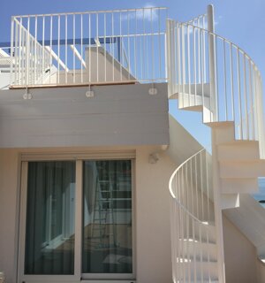 Scala a chiocciola in ferro verniciato bianco per accesso a terrazza privata