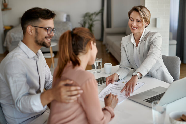 happy-real-estate-agent-having-meeting-with-young-couple-pointing-place-signature-their-contract (1).jpeg