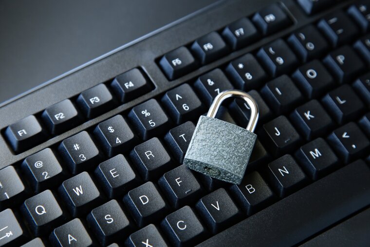 high-angle-shot-lock-black-computer-keyboard-black-surface.jpeg