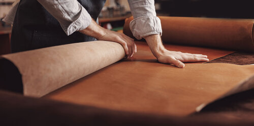 Master leather craftsman selecting leather for production
