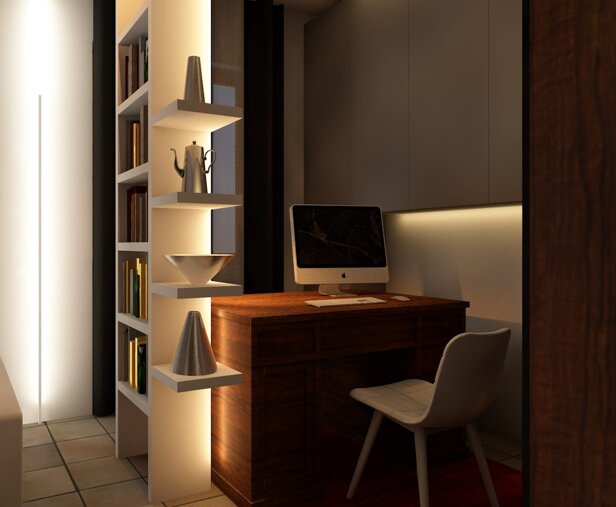 Zona studio ricavata nel salotto, con mobile libreria per separare senza chiudere troppo.