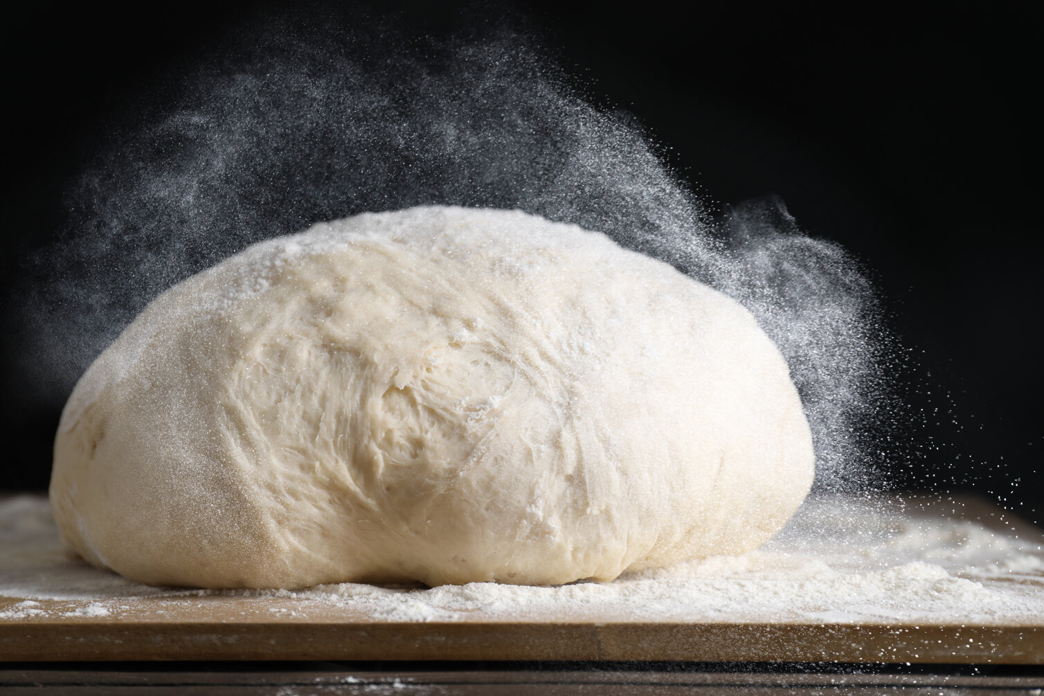 sprinkling-flour-over-dough-on-table-closeup-2026-01-11-11-10-34-utc.jpeg