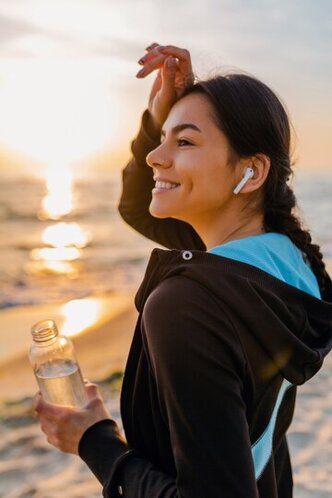 attractive-slim-woman-doing-sport-exercises-morning-sunrise-beach-sports-wear-thirsty-drinking-water-bottle-healthy-lifestyle-listening-music-wireless-earphones-hot-summer-day_285396-5566.jpeg
