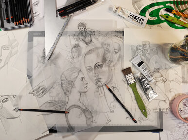 Traditional drawing process of Balbusso Twins featuring detailed female faces hand-sketched with pencils on tracing paper in their Milan art studio.