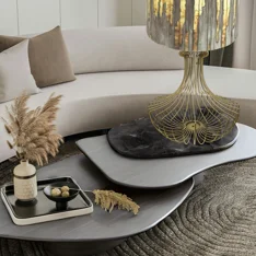 Telaio per base lampada in filo di ferro dorato, con struttura simmetrica e curve eleganti che si aprono verso il basso Telaio per base lampada in filo di ferro dorato, con struttura simmetrica e curve eleganti che si aprono verso il basso
