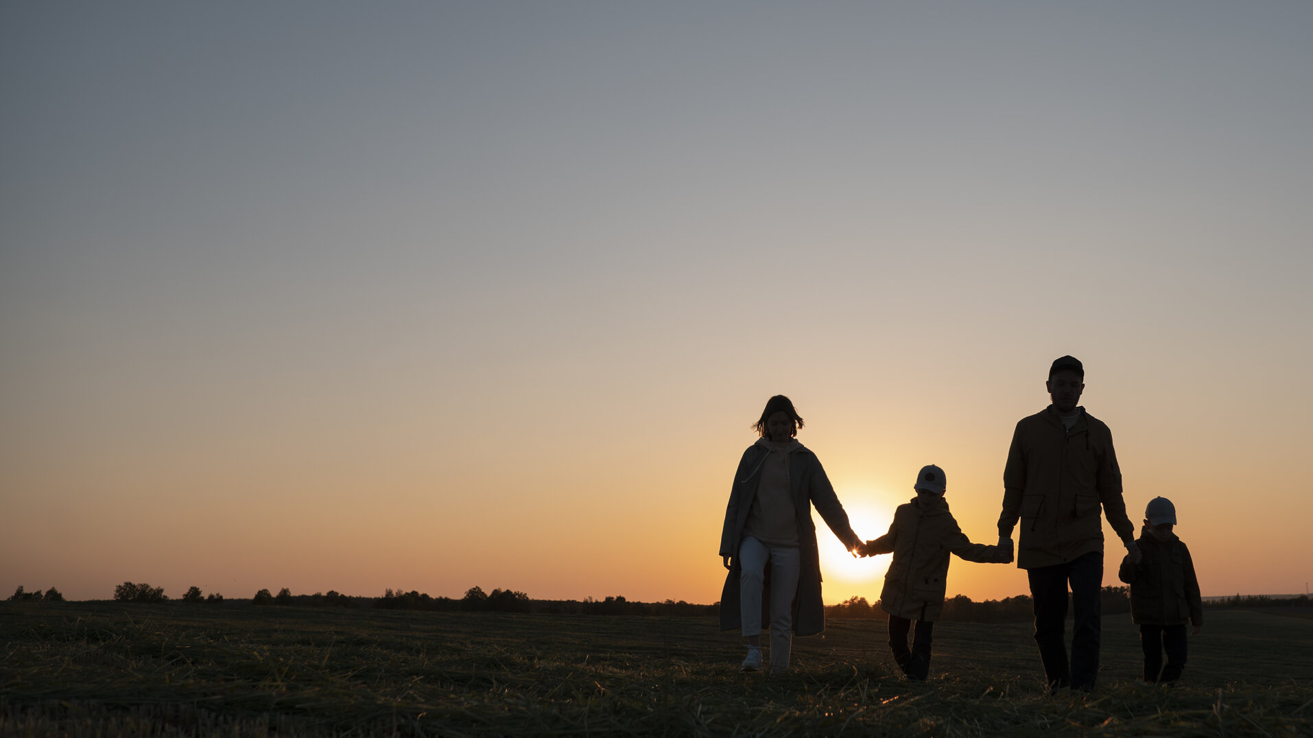 family-silhouettes-having-fun-sunset-full-shot.jpeg