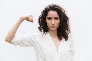 confident-serious-woman-flexing-bicep.jpeg