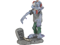 Statuina Les Alpes di uno zombie in stile umoristico, con pelle grigio-azzurra, un grande occhio sbarrato, la lingua penzolante e vestiti strappati, accanto a una lapide di pietra con la scritta 