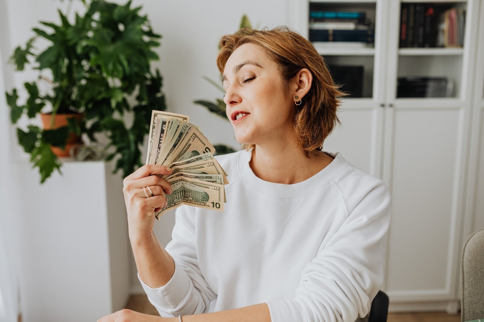 una donna con un ventaglio di banconote