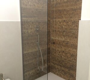 doccia con piatto di tipo sottile e parete in cristallo; rubinetteria in acciaio inox 