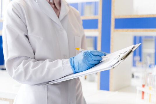 female-scientist-lab-with-notepad.jpeg