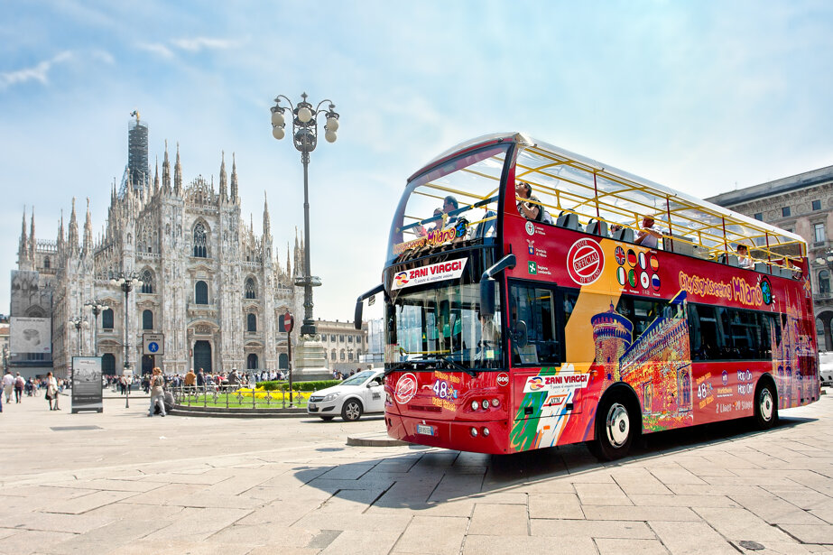 Hop-on hop-off sightseeing bus in front of Milan Duomo, a top attraction in the city center