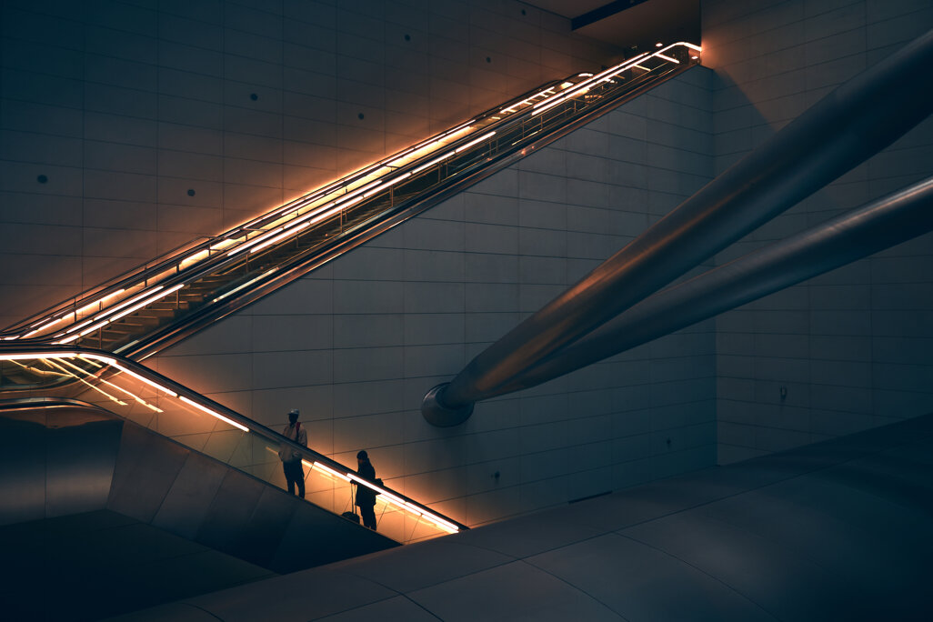 two-person-standing-escalator.jpeg