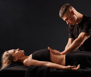 handsome-male-masseur-doing-massage-girl-s-leg-black-background-concept-therapeutic-relaxing-massage.jpeg