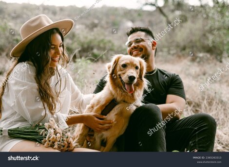 stock-photo-couple-laughing-with-dog-at-park-2365263313.jpeg