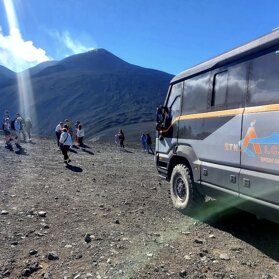 On top of Mount Etna by big off-road vehicles