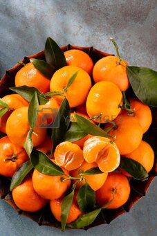 fresh mandarin oranges fruit or tangerines with leaves in wooden box, top view by gitusik vectors & illustrations with unlimited downloads - yayimages.jpeg