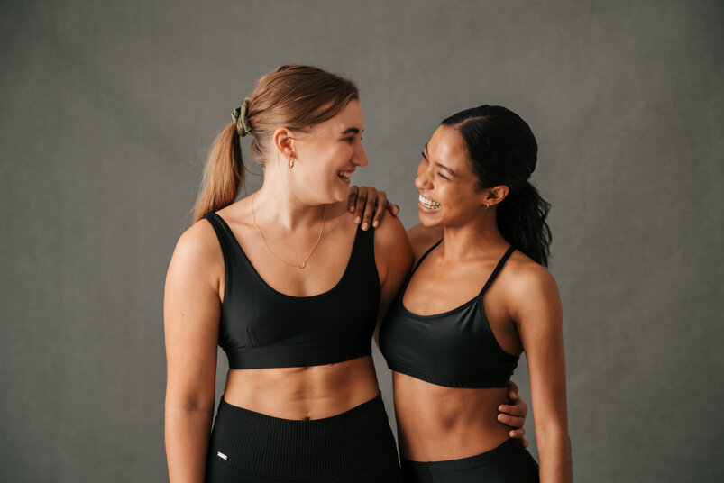 two-girls-arm-arm-smiling-laughing-after-great-work-out.jpeg