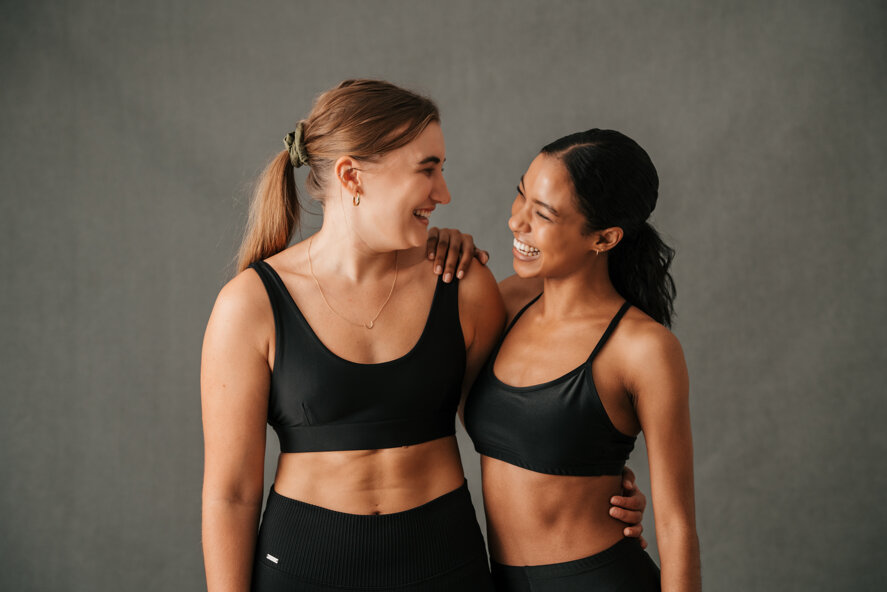 two-girls-arm-arm-smiling-laughing-after-great-work-out.jpeg