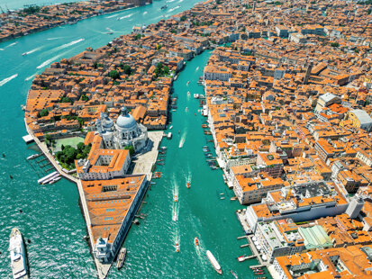 aerial-drone-view-venice-italy-water-channels-with-multiple-floating-moored-boats.jpeg
