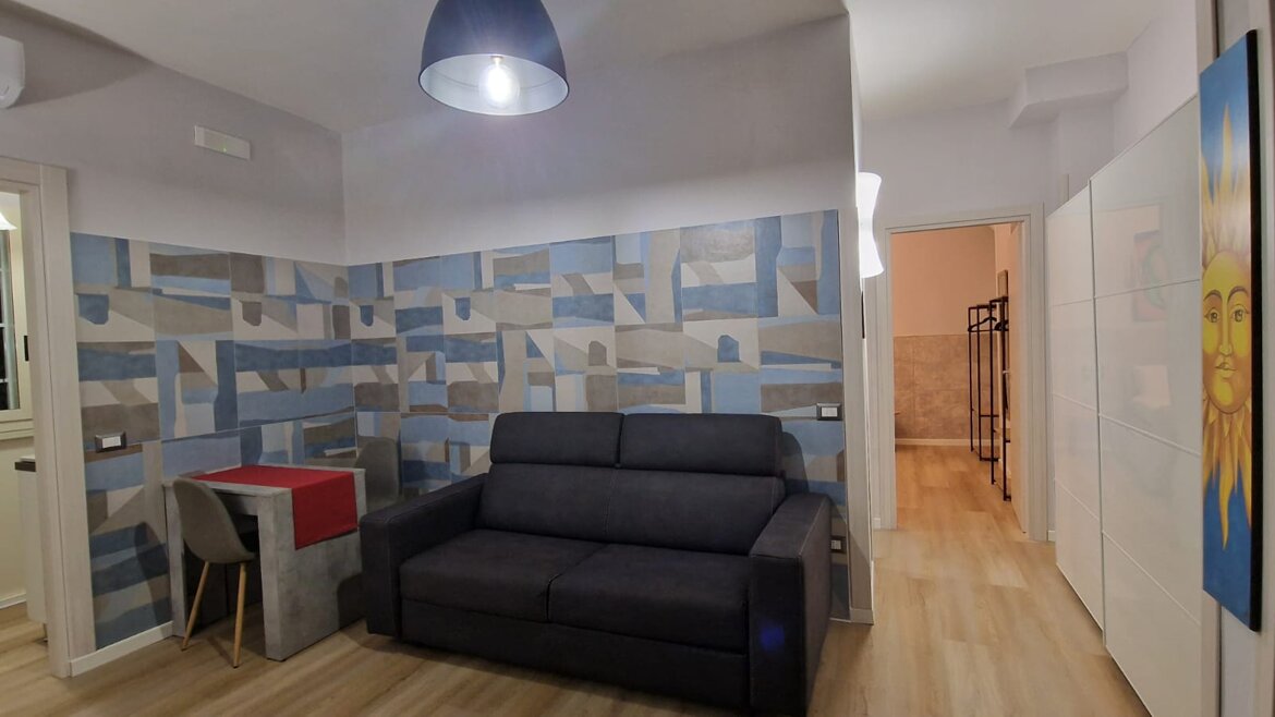 Soggiorno con divano letto matrimoniale, condizionatore, smart tv