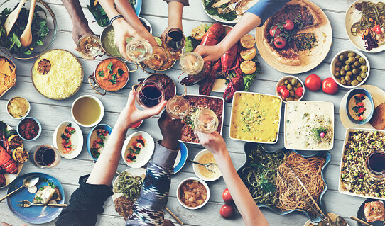 515741052-friends-happiness-enjoying-dinning-eating-concept_1
