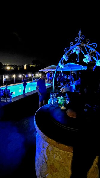 Atmospheric night lighting by the pool with coloured spotlights for exclusive events