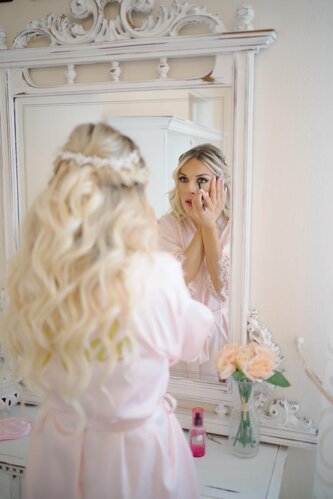 Bride getting ready with make-up in the Villa Malvasio Suite in Sassari