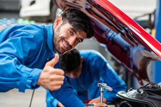 vecteezy_happy-smile-caucasian-male-mechanic-showing-thumbs-up-while_6948112.jpeg