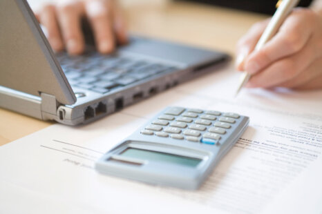459597095-womans-hands-calculating-home-finances-at-desk 459597095-womans-hands-calculating-home-finances-at-desk