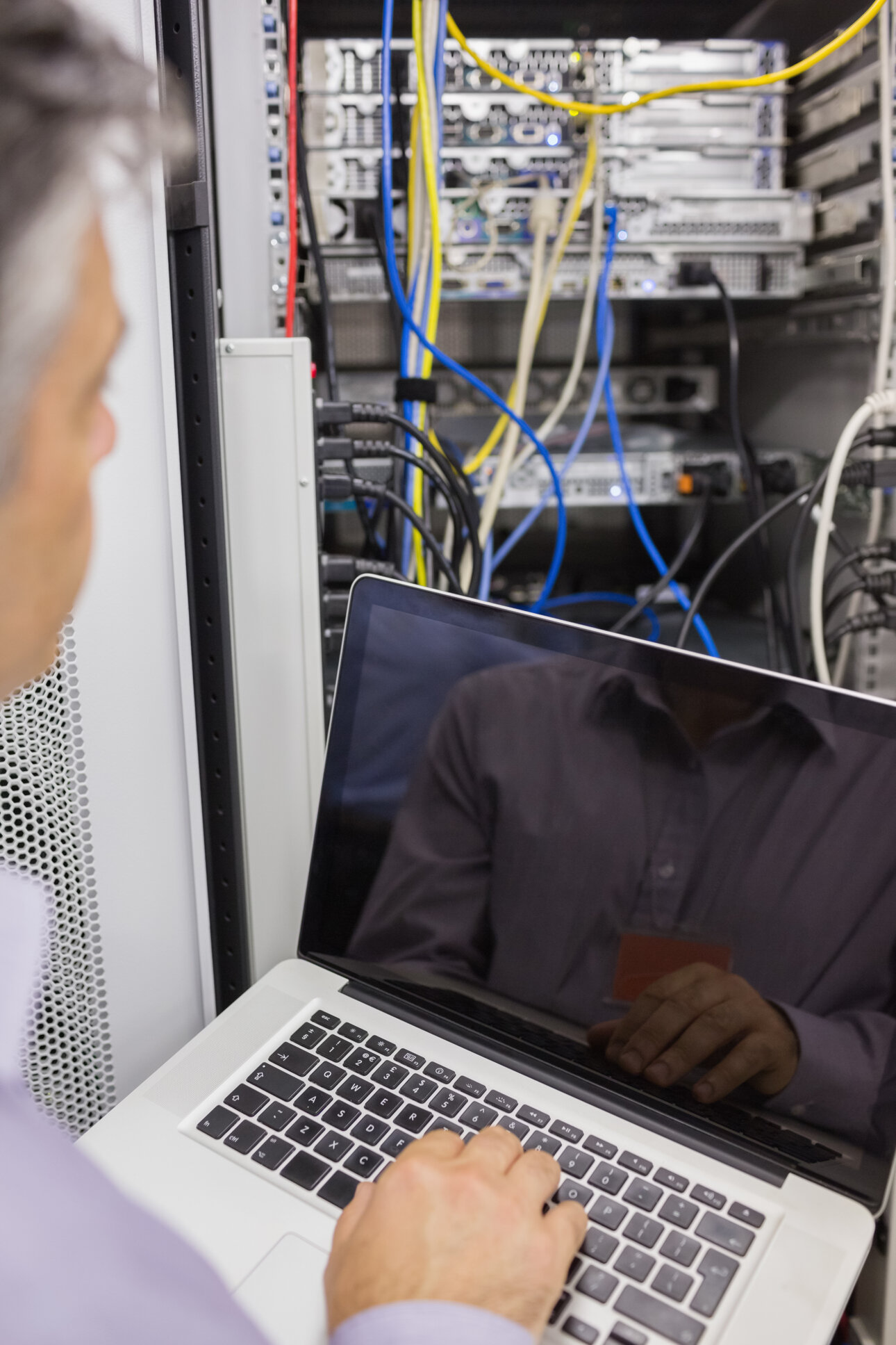 man-sitting-with-laptop-front-server.jpeg