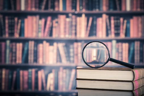 519427336-books-and-magnifying-glass
