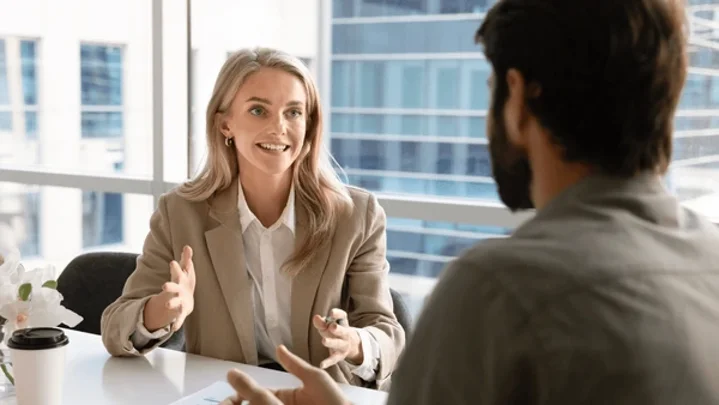 happy-blonde-young-businesswoman-talking-600nw-2695542205