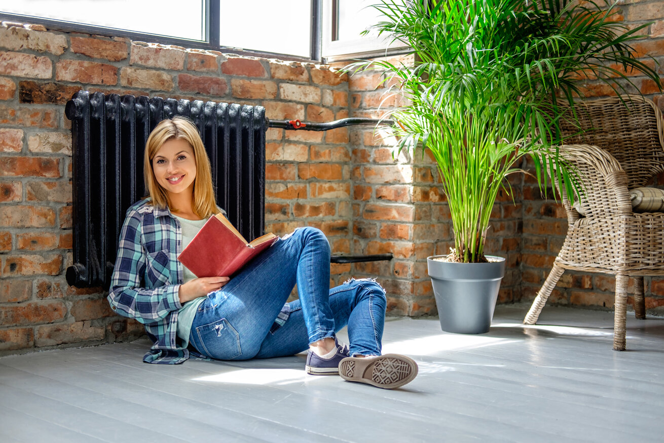 attractive-casual-blond-female-sitting-floor-reading-book-living-room.jpeg