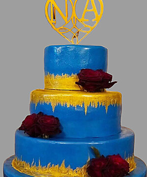 Torta in pasta di zucchero blu con sfumature oro e rose rosse