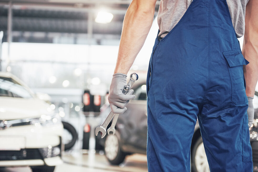 hands-car-mechanic-with-wrench-garage.jpeg