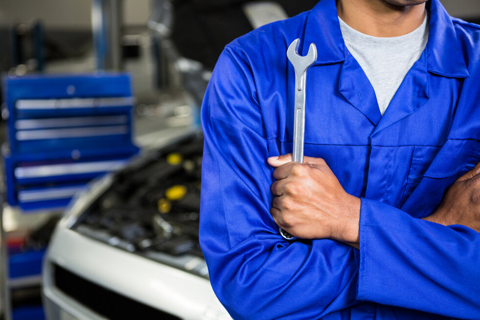 mechanic-with-arms-crossed-holding-spanner.jpeg
