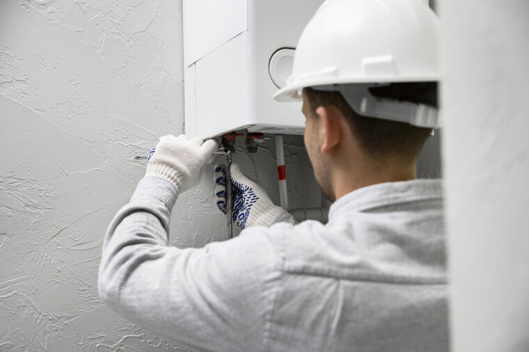 worker-repairing-water-heater.jpeg
