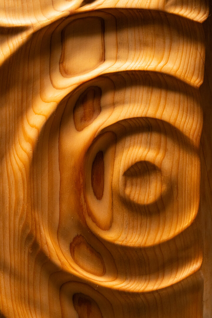 Dettaglio di opera scultorea in legno con superfici fluide e lavorazione artigianale Dettaglio di opera scultorea in legno con superfici fluide e lavorazione artigianale