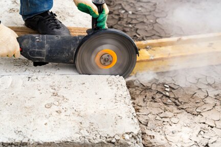 close-up-worker-cuts-concrete-with-circular-saw.jpeg