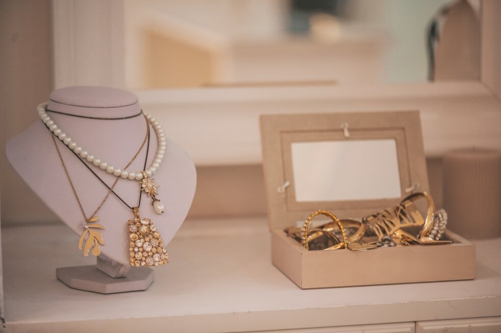 luxury-gold-jewelry-on-set-holders-and-in-jewelry-box-on-light-dressing-table-and-wardrobe-shelves.jpeg luxury-gold-jewelry-on-set-holders-and-in-jewelry-box-on-light-dressing-table-and-wardrobe-shelves.jpeg