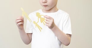 child-with-paper-family-shape.jpeg child-with-paper-family-shape.jpeg