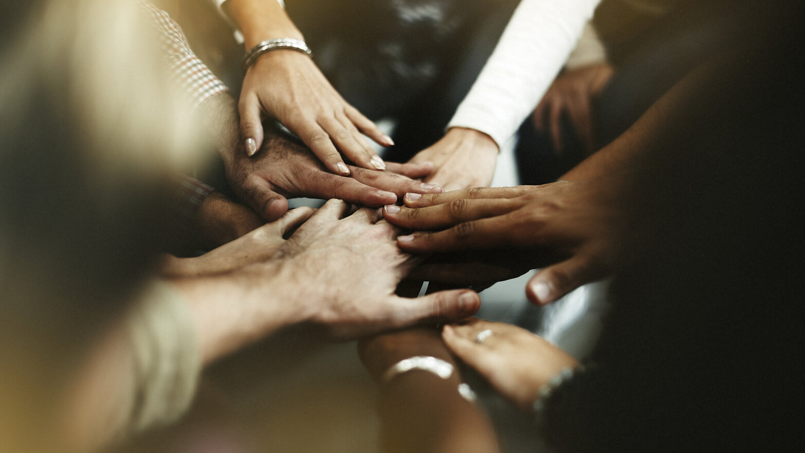 closeup-diverse-people-joining-their-hands.jpeg