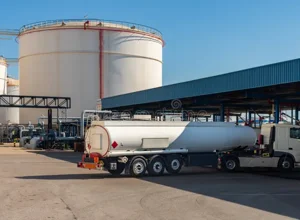 238111816-fuel-tanker-truck-speeding-toward-refueling-stations-and-highway-noise-barriers-on-the-road.jpeg