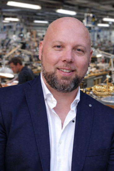 uomo sorridente in officina orafa